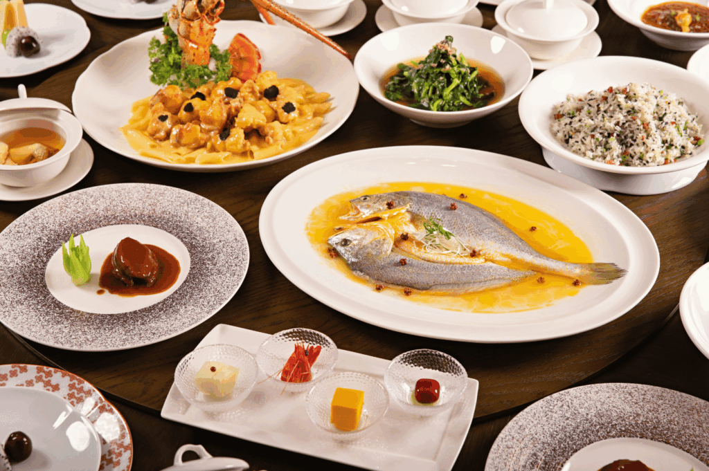 A vibrant spread of Singapore fusion dishes on a communal table, mixing Southeast Asian staples with global twists, as chefs share plates family-style.