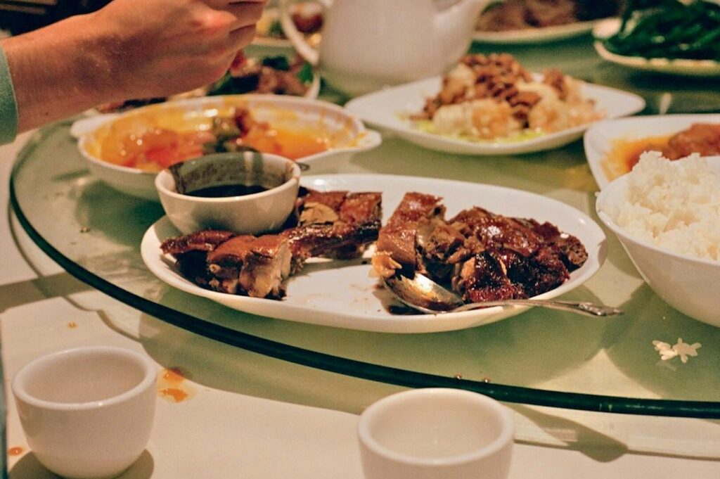 A person eating Peranakan Food, showcasing a modern dining experience in a Singaporean restaurant.