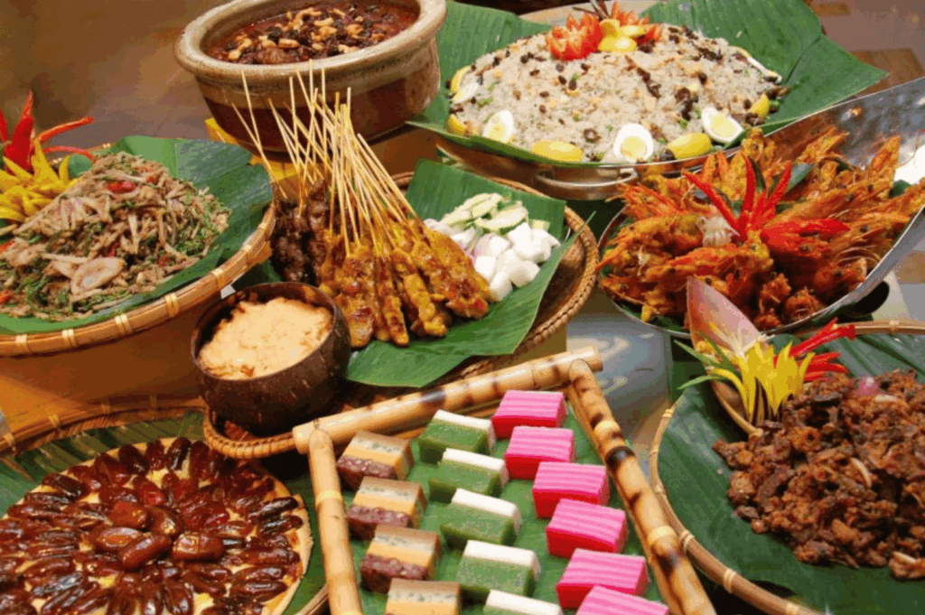 Festive spread with satay skewers, rendang, colorful kuih, and rice dishes on banana leaves—reflecting the communal richness and regional flavors that shape Singapore’s Michelin culinary journey.