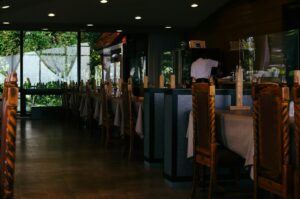 Interior of a restaurant showcasing a long table, designed for upscale dining experiences in Singapore's Michelin-starred scene.