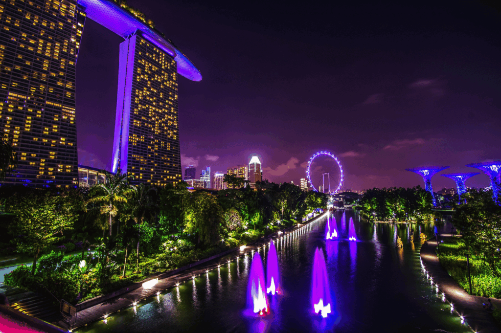 Night view of Marina Bay Sands, Supertree Grove, and Singapore Flyer with vibrant purple and blue lighting—capturing the city’s iconic skyline and its evolution into a global dining and design destination.