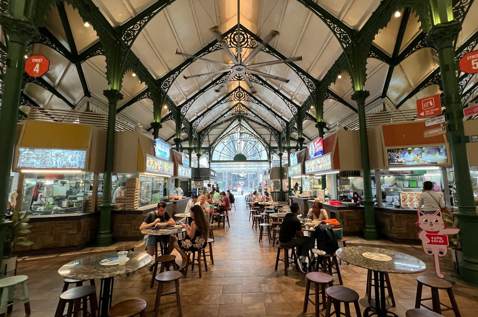 A food court at Singapore, filled with diverse food stalls offering a wide range of culinary delights.