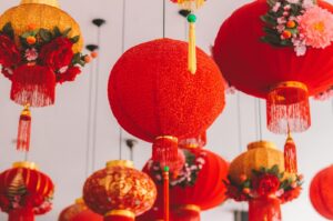 A vibrant display of red and gold lanterns hanging from the ceiling, celebrating the festive spirit of Chinese New Year.