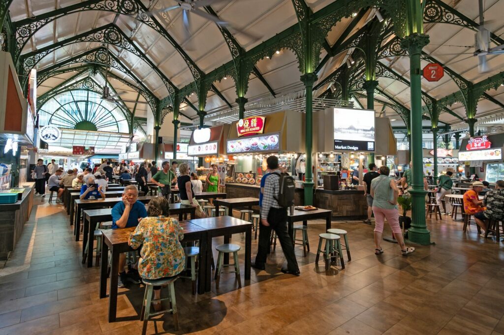 The lively food court at Singapore market, featuring diverse stalls offering authentic local cuisine and a vibrant atmosphere.