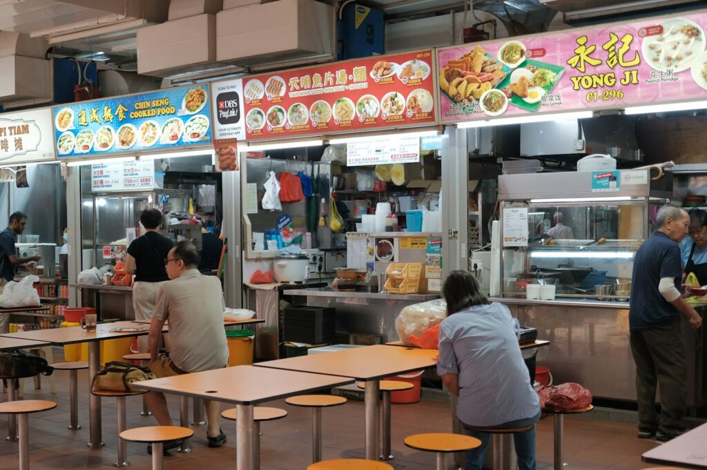 A bustling restaurant in Little India featuring numerous tables and chairs for dining.