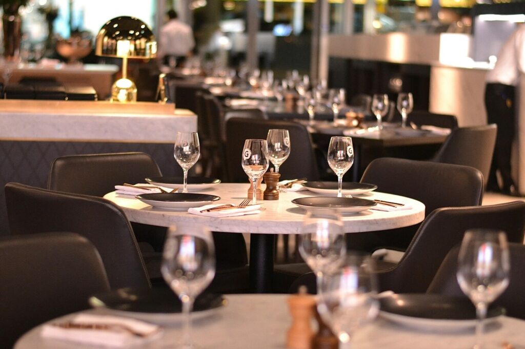 An upscale dining area in Singapore with unoccupied tables and chairs, showcasing a serene restaurant environment.