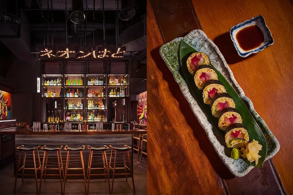Dimly lit Japanese bar with sleek wooden stools and a neon sign. On the right, a platter of sushi rolls garnished with pickled ginger and wasabi.