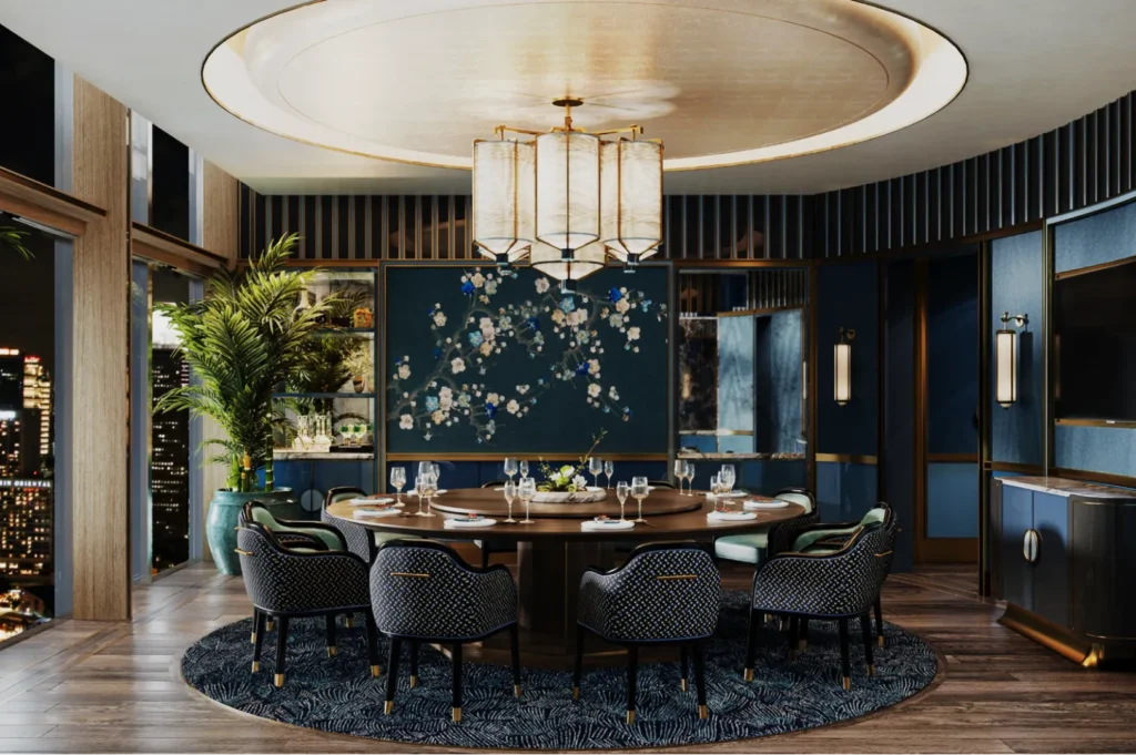 Luxurious dining room with round table set for dinner, surrounded by elegant chairs. Large chandelier overhead, city skyline visible through windows.