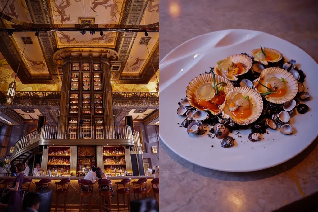 A grand, ornate bar with a towering liquor display and elegant ceiling fresco. On the right, a dish of scallops and shells artfully plated on a white dish.