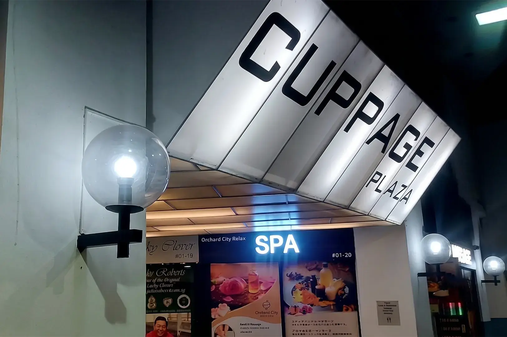 Cuppage Plaza building entrance sign with Orchard City Relax Spa storefront visible below.